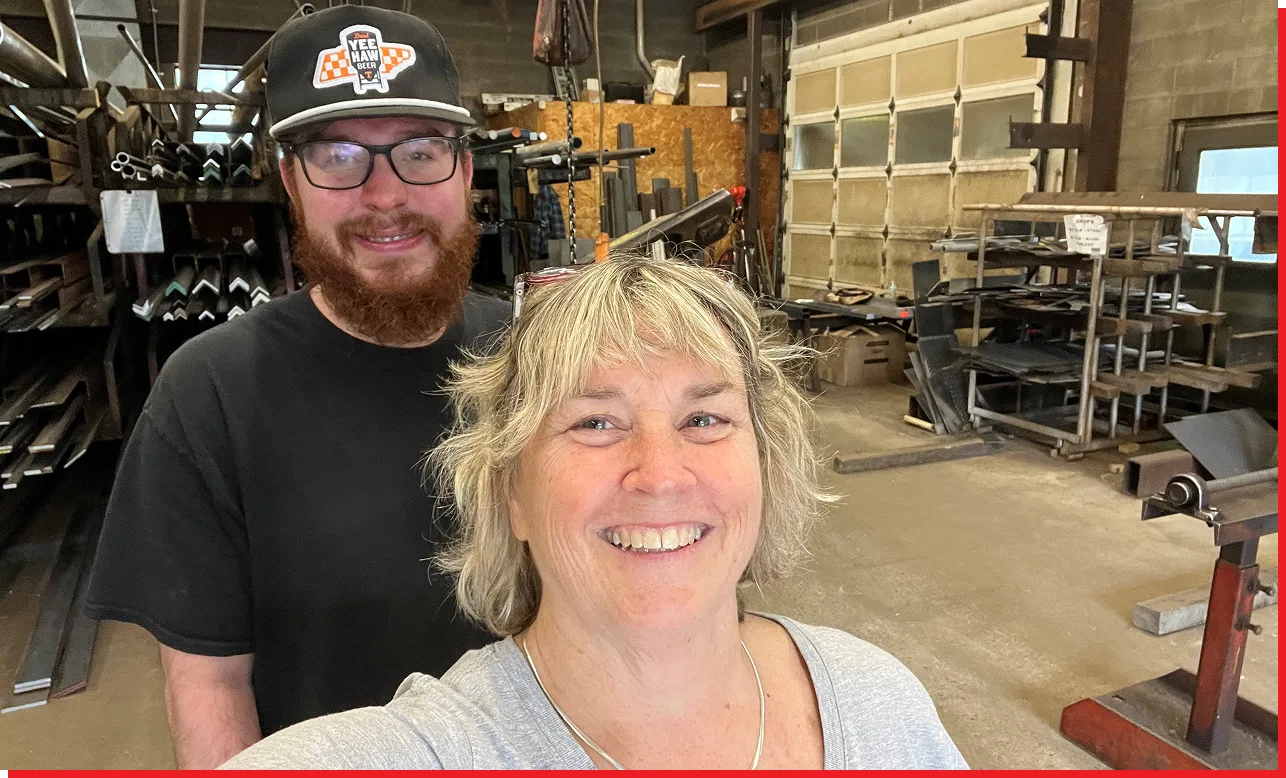 Man and woman standing next to each other in a workshop